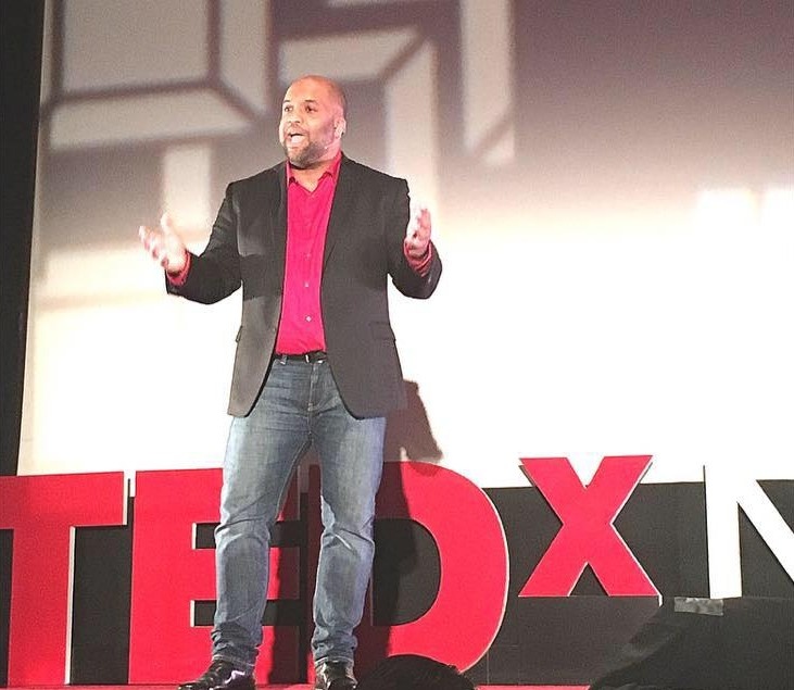 Mike Veny, workplace mental health speaker, delivering a TEDx talk.