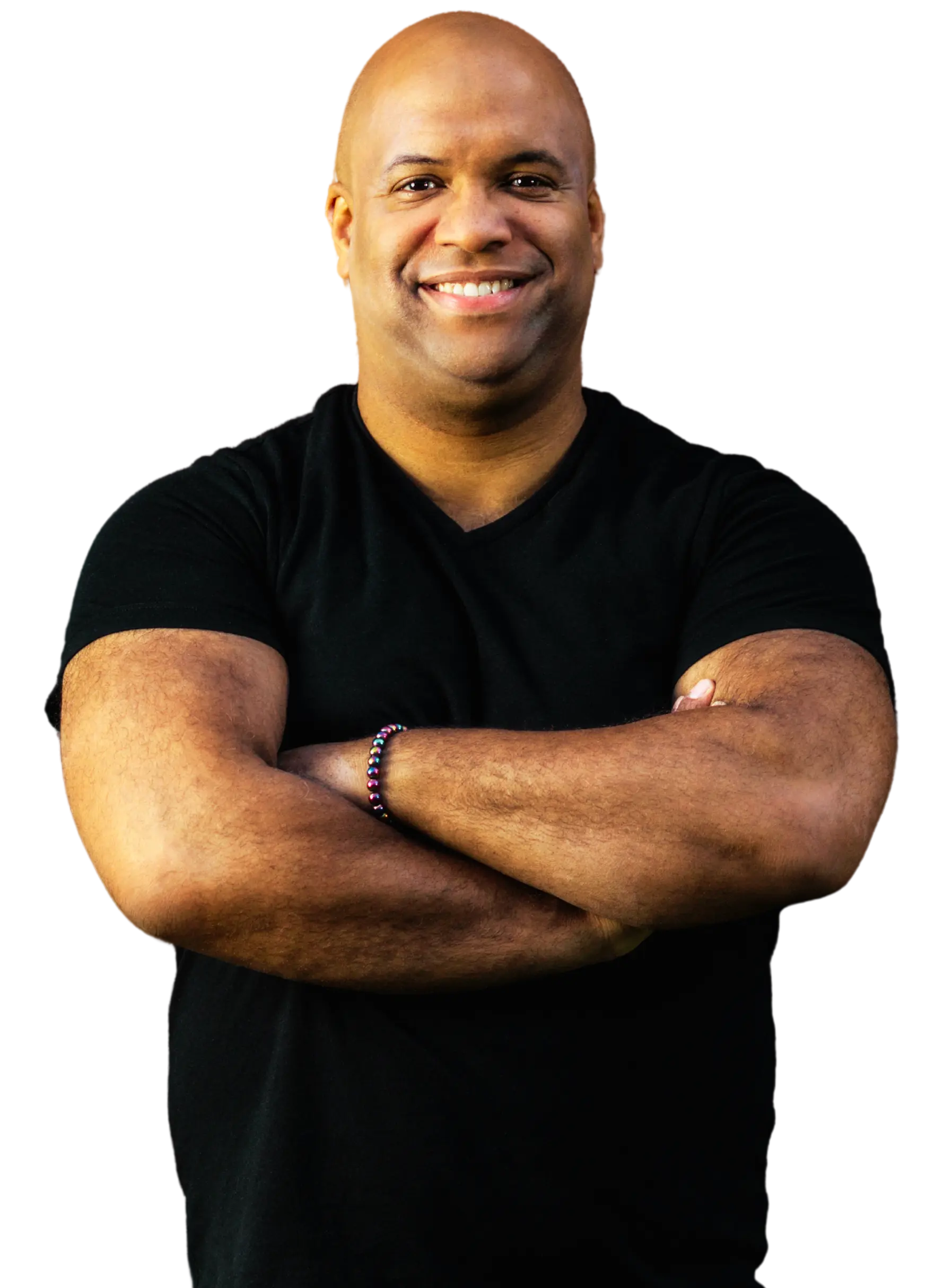 The image features Mike Veny, a bald man with a warm smile, wearing a black t-shirt and a beaded bracelet on his left wrist. He has his arms crossed and exudes confidence and approachability. The background is removed, making the subject stand out prominently.